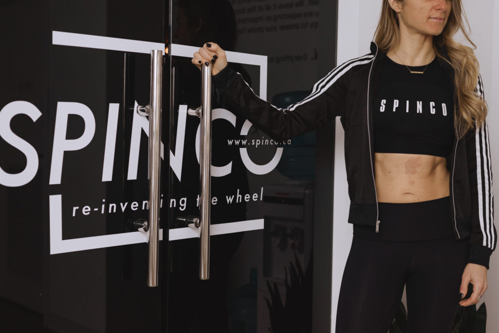 spin instructor about to open doors to spin studio