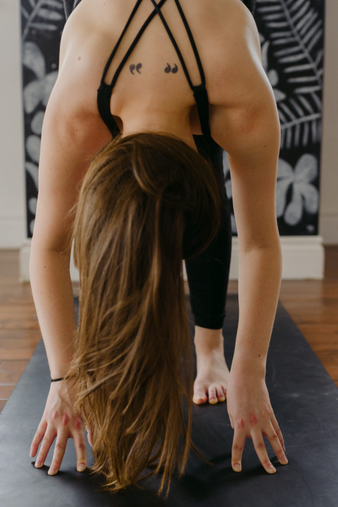 yoga teacher in forward fold