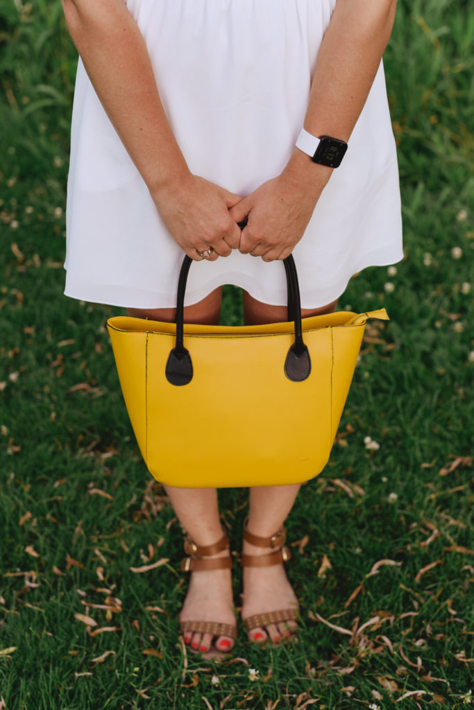 content marketing specialist holding onto yellow purse