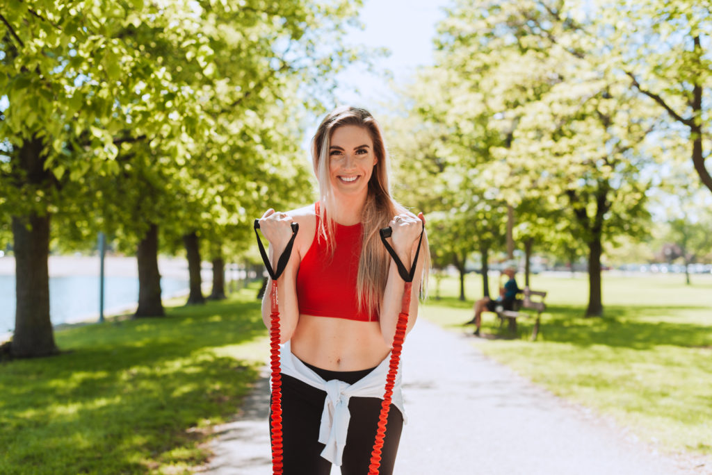 fitness coach with red band in a park