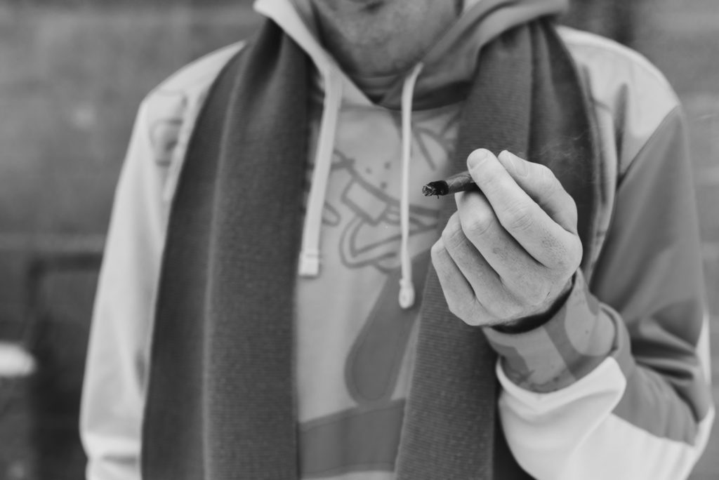 ottawa cannabis expert holding a joint outdoors