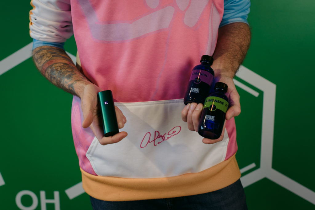 Angelo holding cannabis terpenes and vaporizer