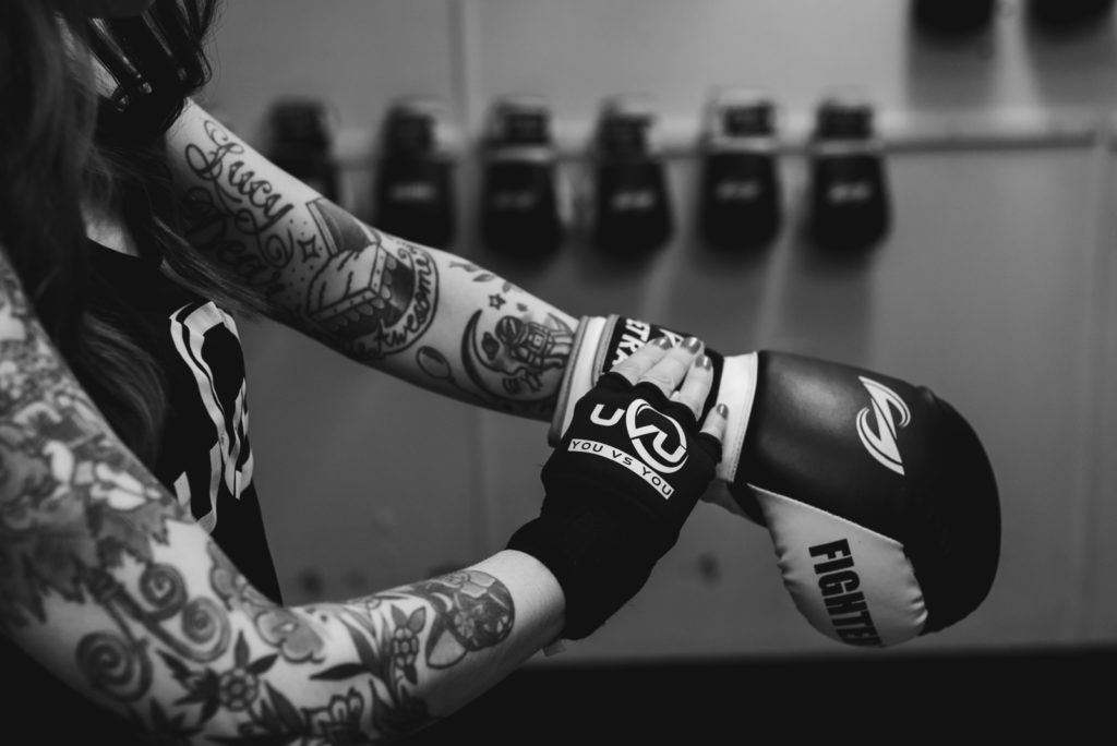 student putting on boxing gloves