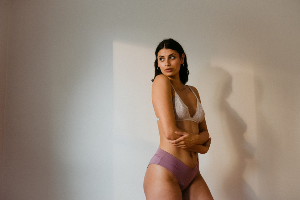 indie lingerie model wearing mauve underwear and white bralette