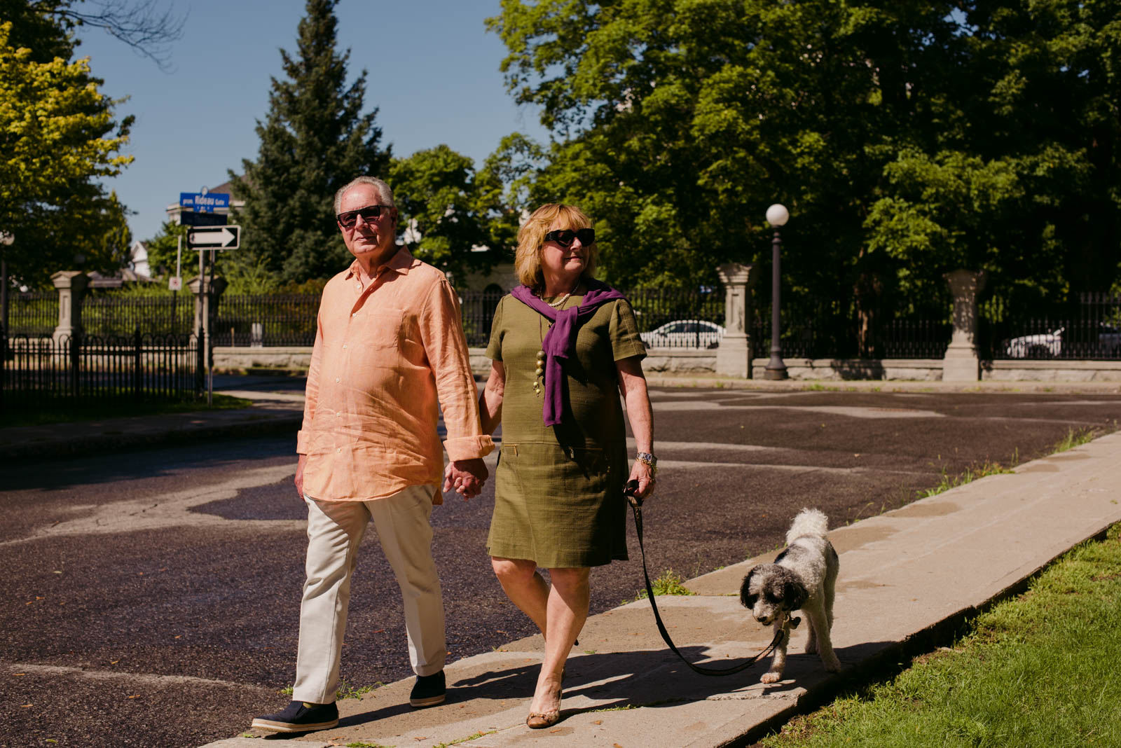 real estate agent team walking their dog by Rideau Hall in Ottawa