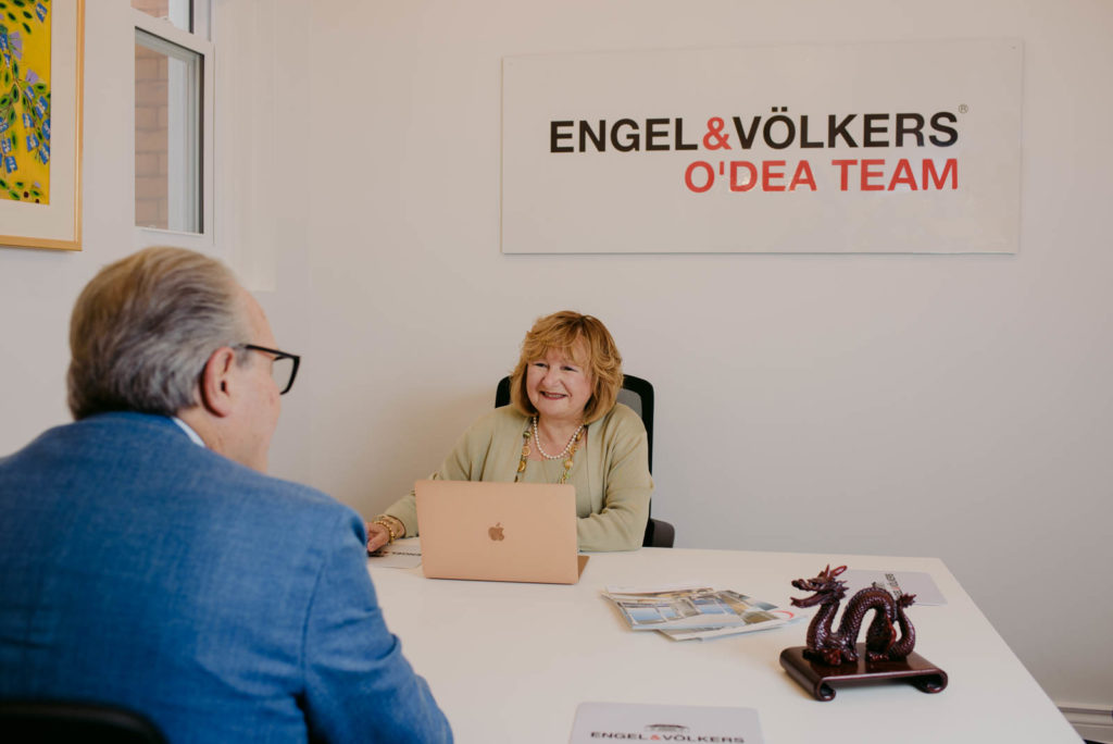 real estate agents Frank and Nancy O'Dea at their desk in Engel and Volkers office