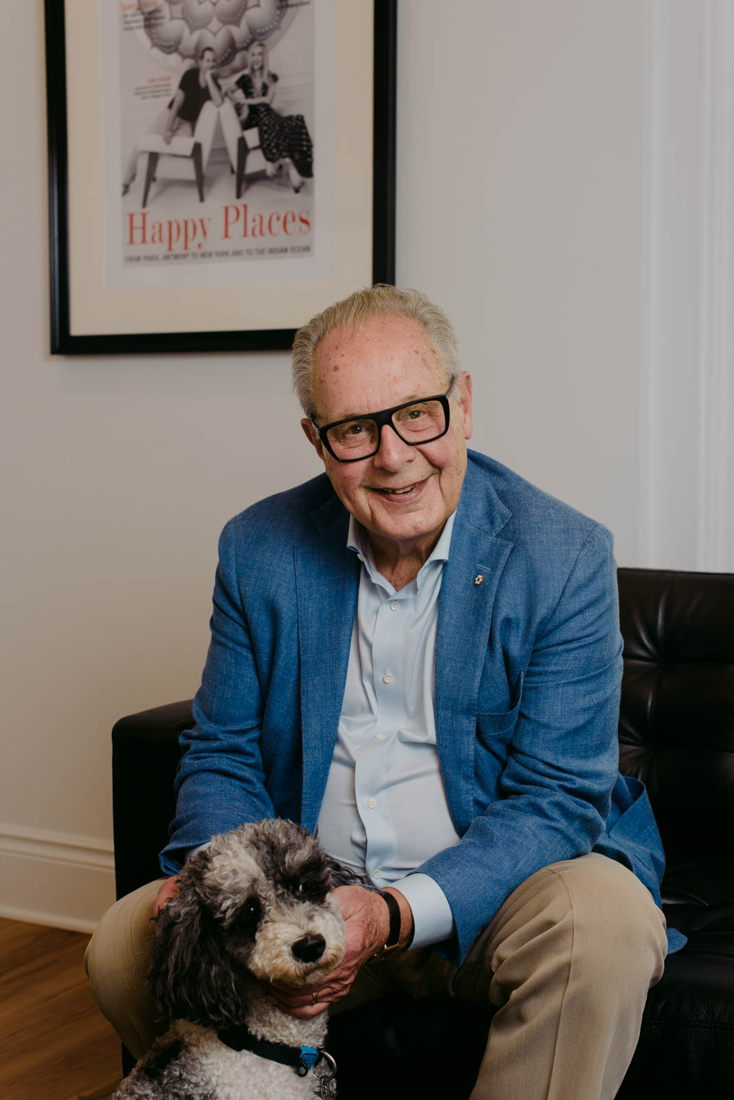 Real estate agent Frank O'Dea with dog sitting on a couch