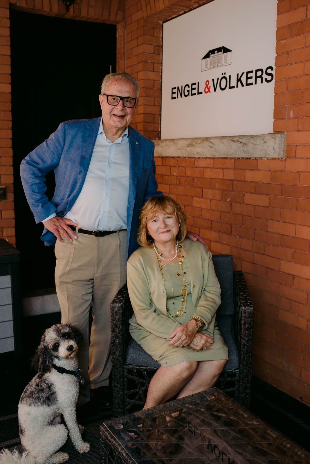 real estate agent team Nancy and Frank O'Dea on patio of Engel and Volkers real estate office