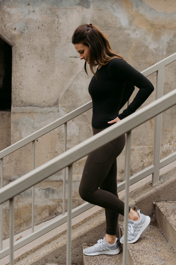 physiotherapist in lululemon apparel walking down a staircase