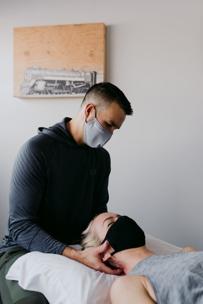 physiotherapist treating client's neck