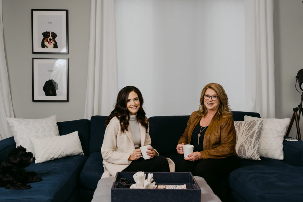 business women on the couch with coffee smiling