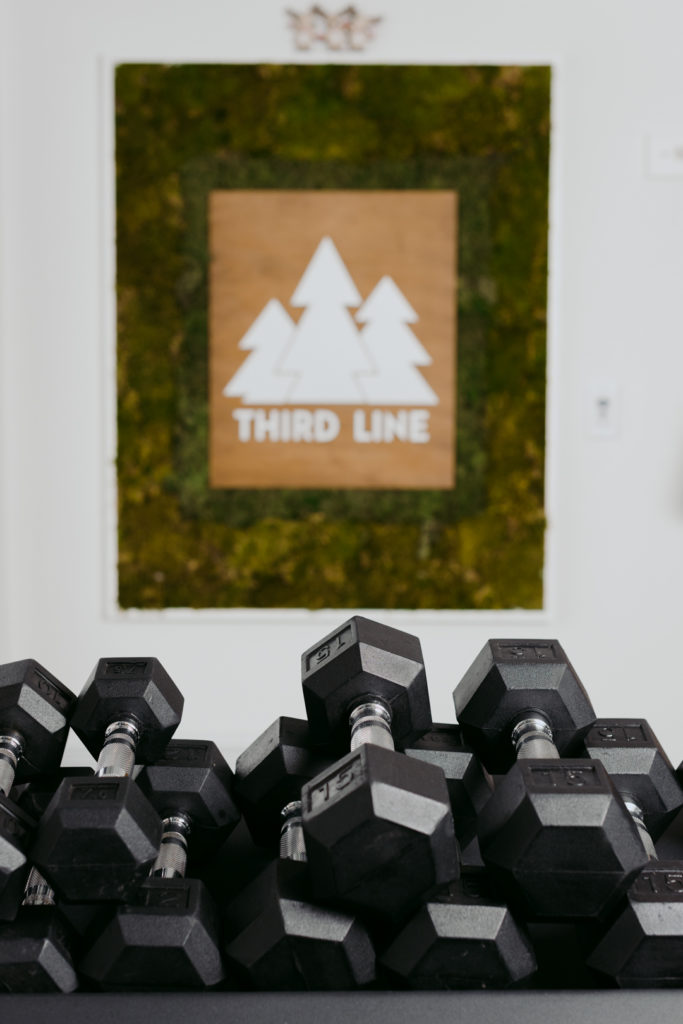 dumbbells stacked on top of each other with Third Line logo in the background