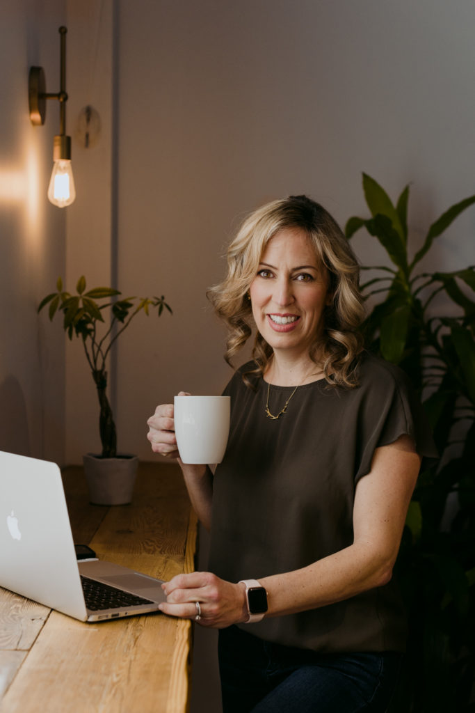Sarah Hunter real estate agent sipping coffee with her laptop