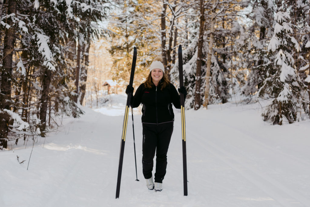 real estate agent holding up cross country skis in gatineau park