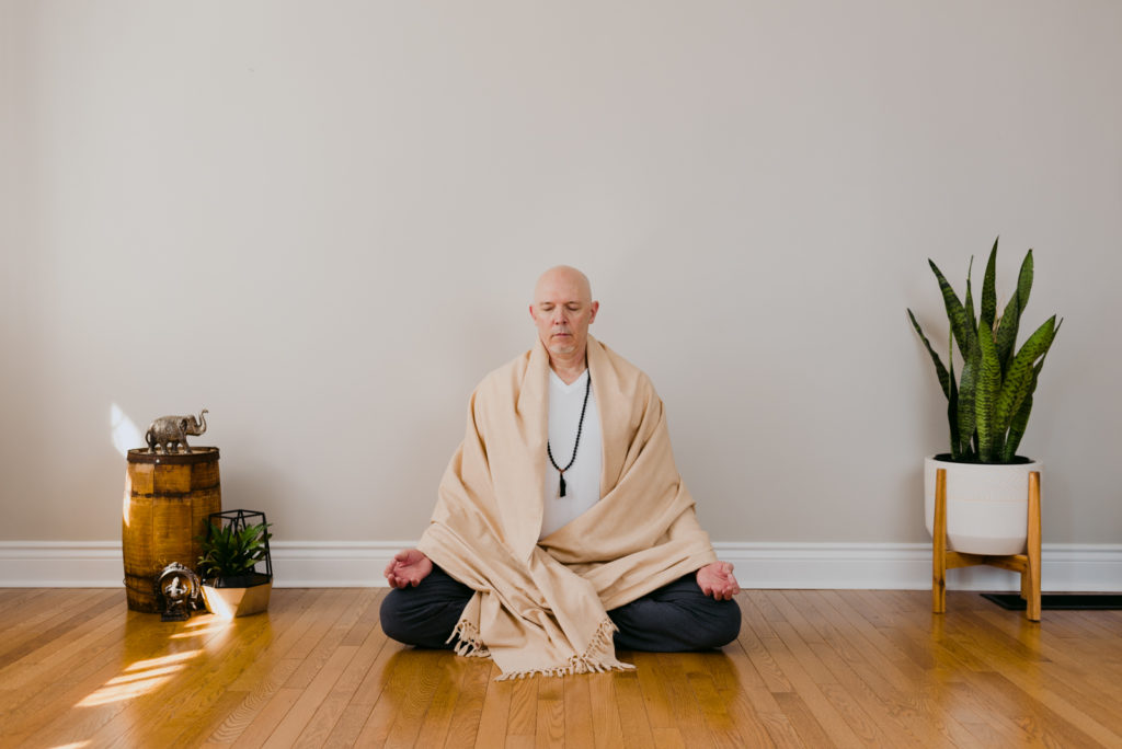 yoga teacher in seated meditation