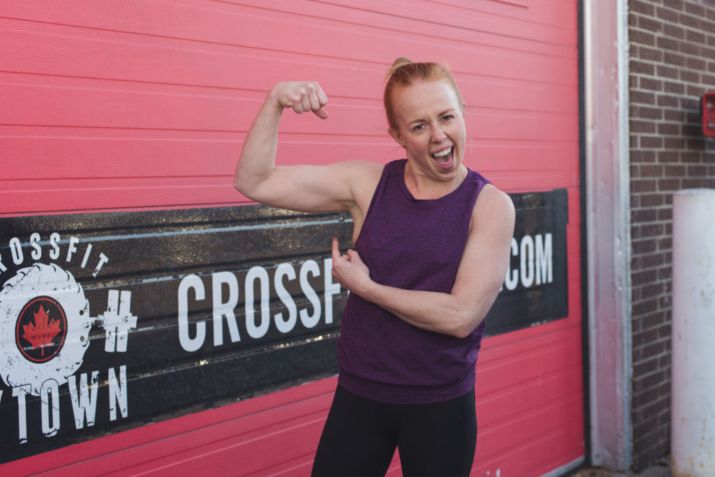 Stephanie Kay outside Bytown Crossfit gym flexing