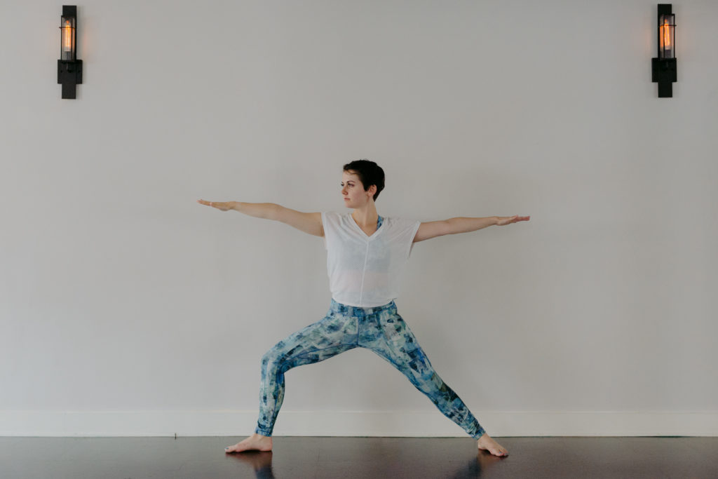 yoga teacher in warrior 2 pose