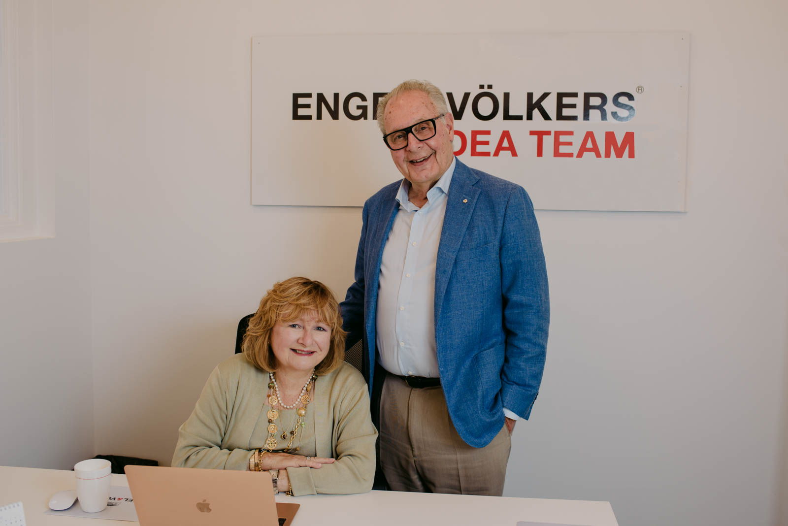 real estate agents Frank and Nancy O'Dea at their desk in Engel and Volkers office
