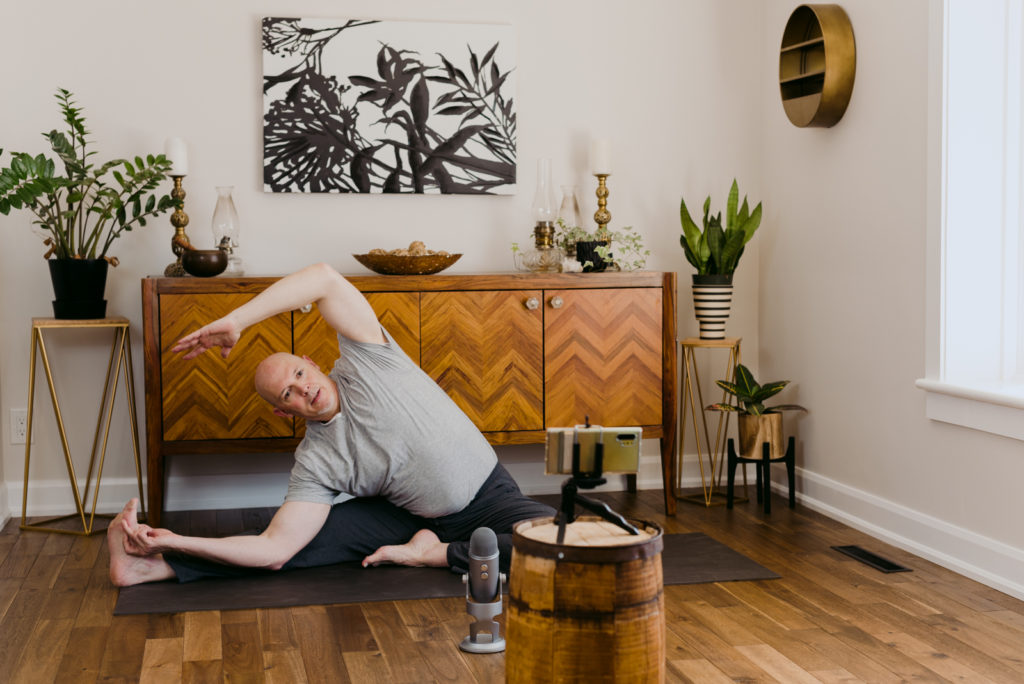 yoga teacher leading virtual yoga class at home