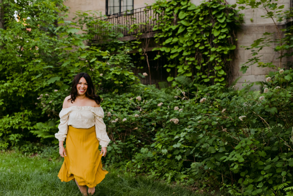 woman wearing yellow skirt outside an old castle