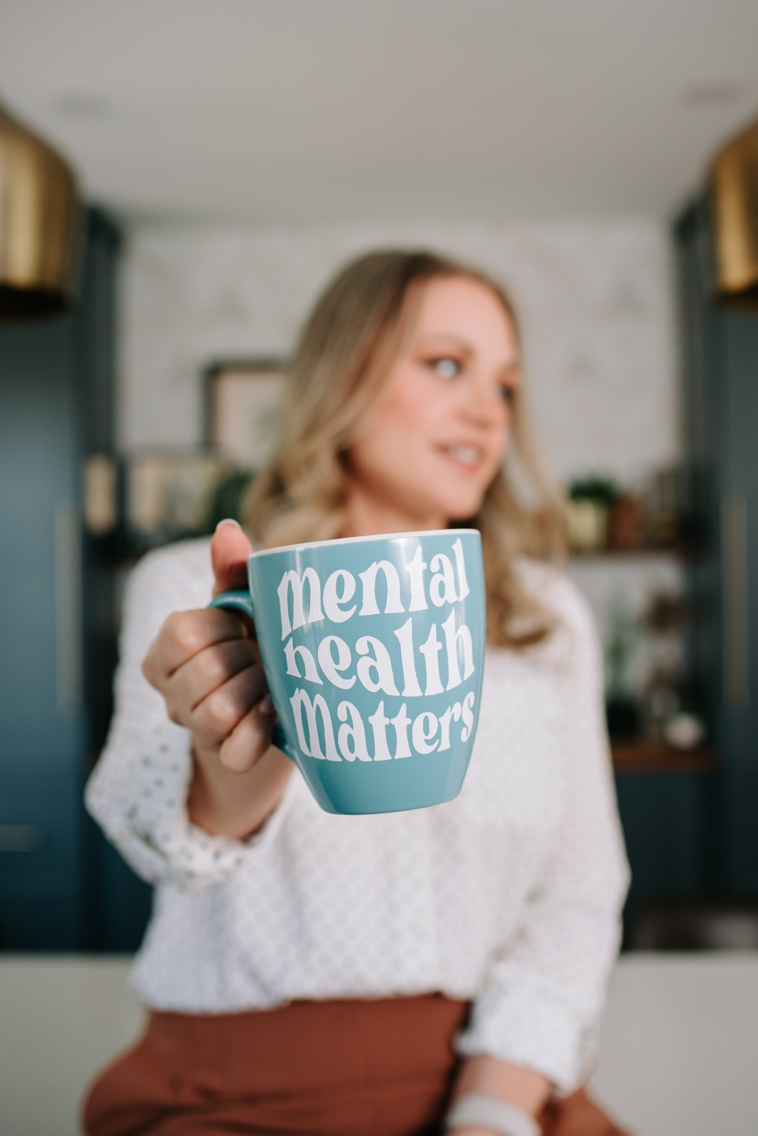 ottawa psychotherapist with coffee mug that says "mental health matters"