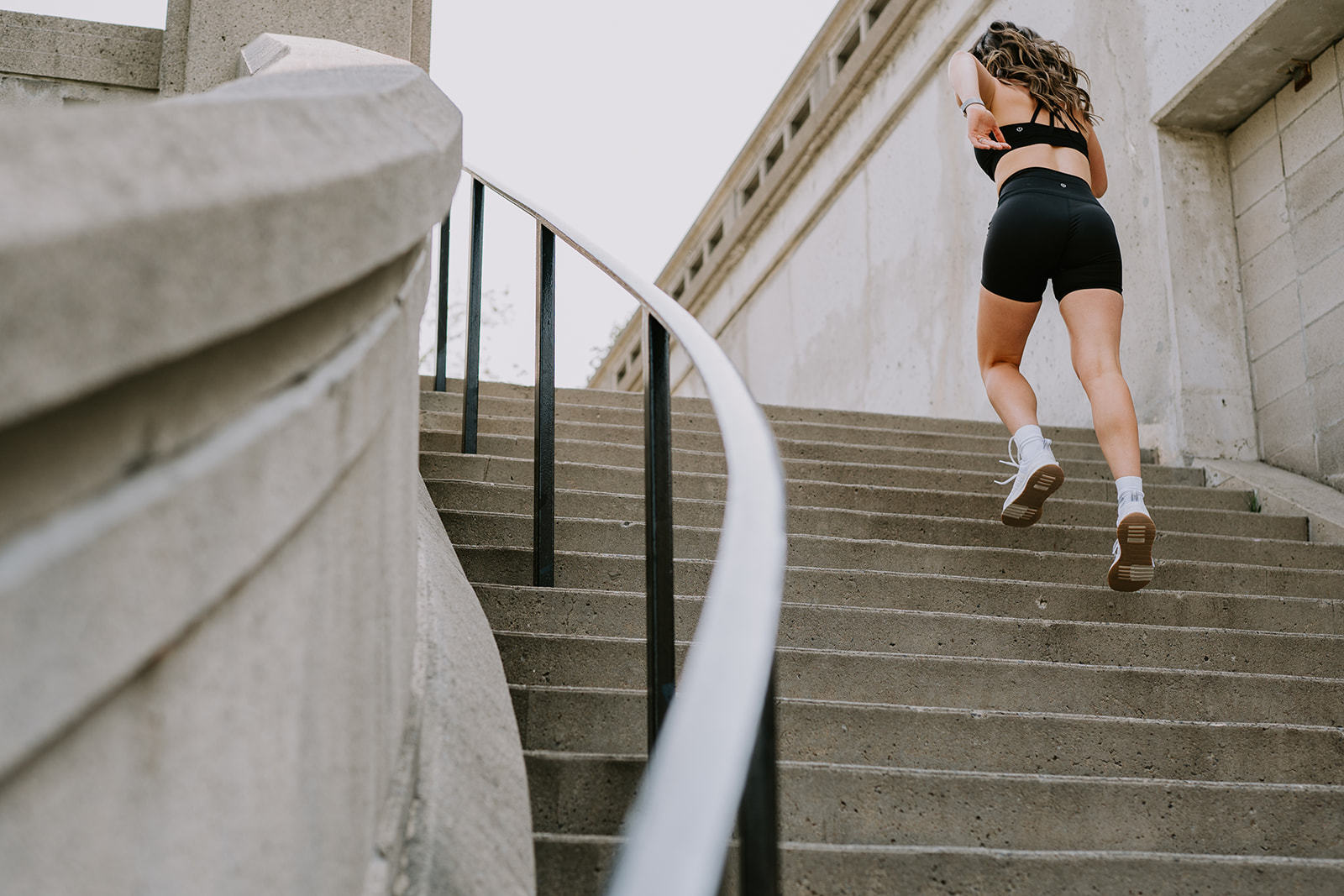 athletic woman running up staircase